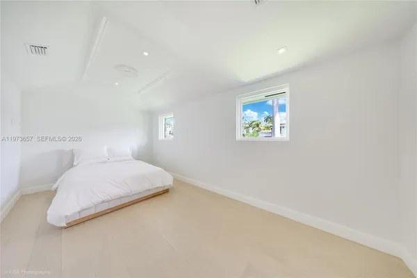 a bedroom with a bed and a painting