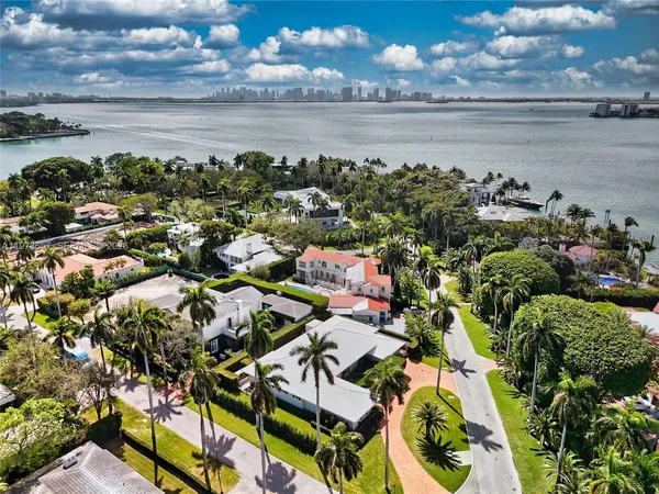 an aerial view of a house with swimming pool garden and patio