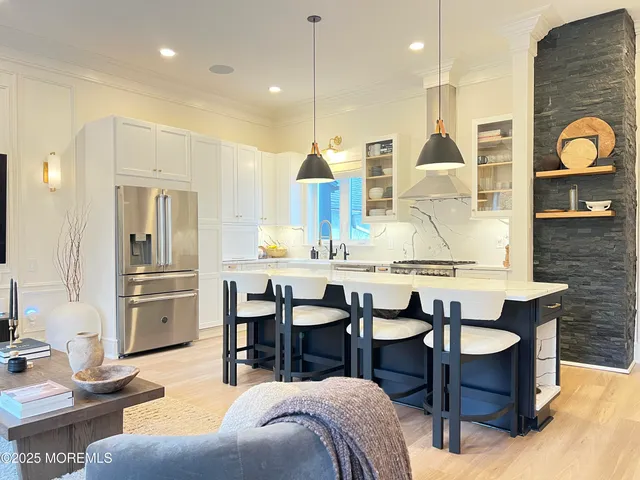 a kitchen with granite countertop a sink cabinets and stainless steel appliances