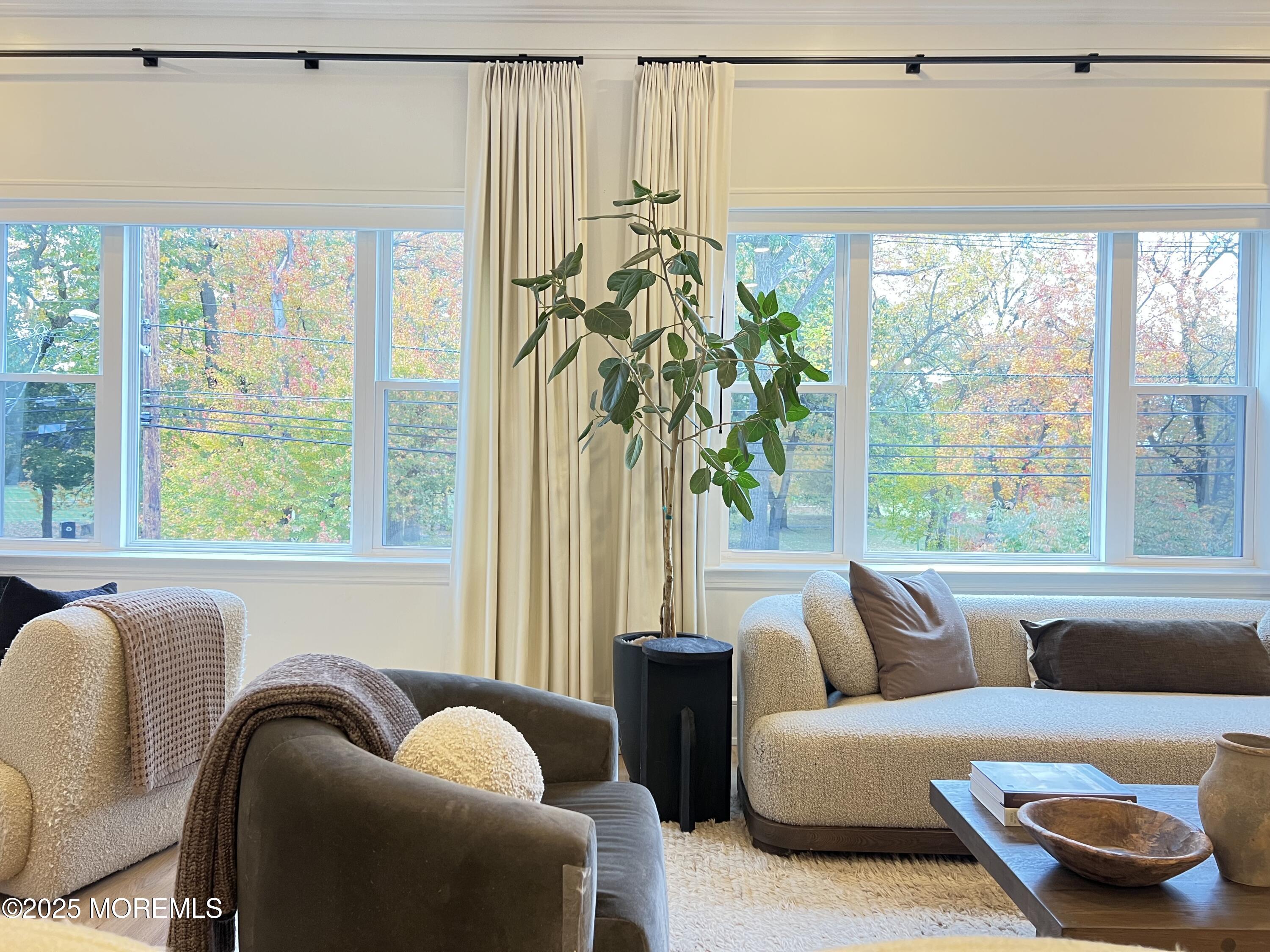 164 Glenwood Avenue, Unit 201 Bloomfield, NJ 07003 - Photo 13 of 26 a living room with furniture and a large window
