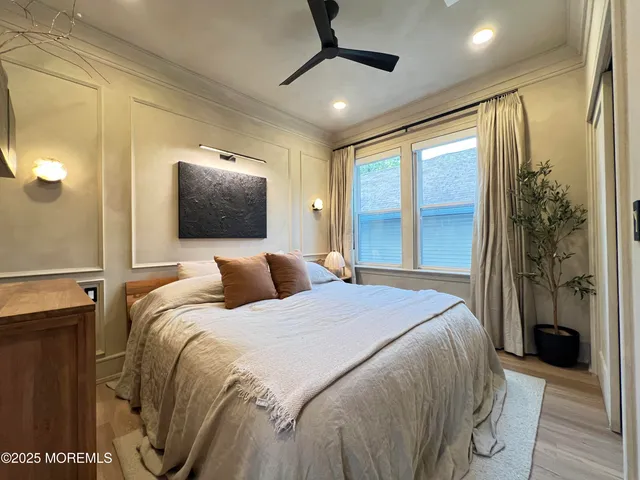 a bedroom with a large bed and a chandelier