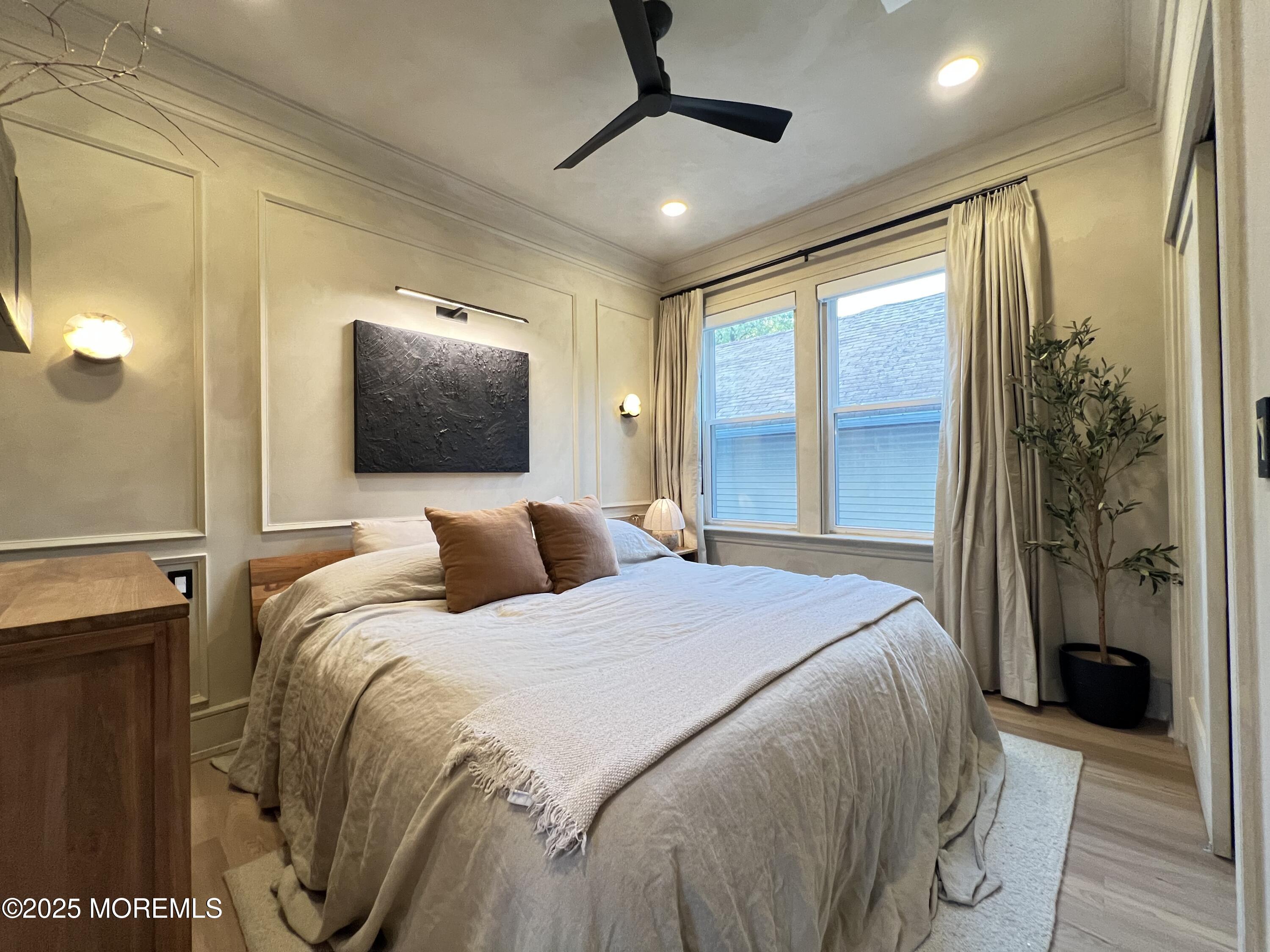 164 Glenwood Avenue, Unit 201 Bloomfield, NJ 07003 - Photo 19 of 26 a bedroom with a large bed and a chandelier