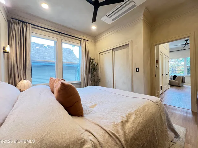 a bedroom with a large bed and a large window