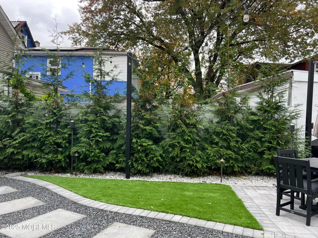 a view of a chairs and table in the backyard