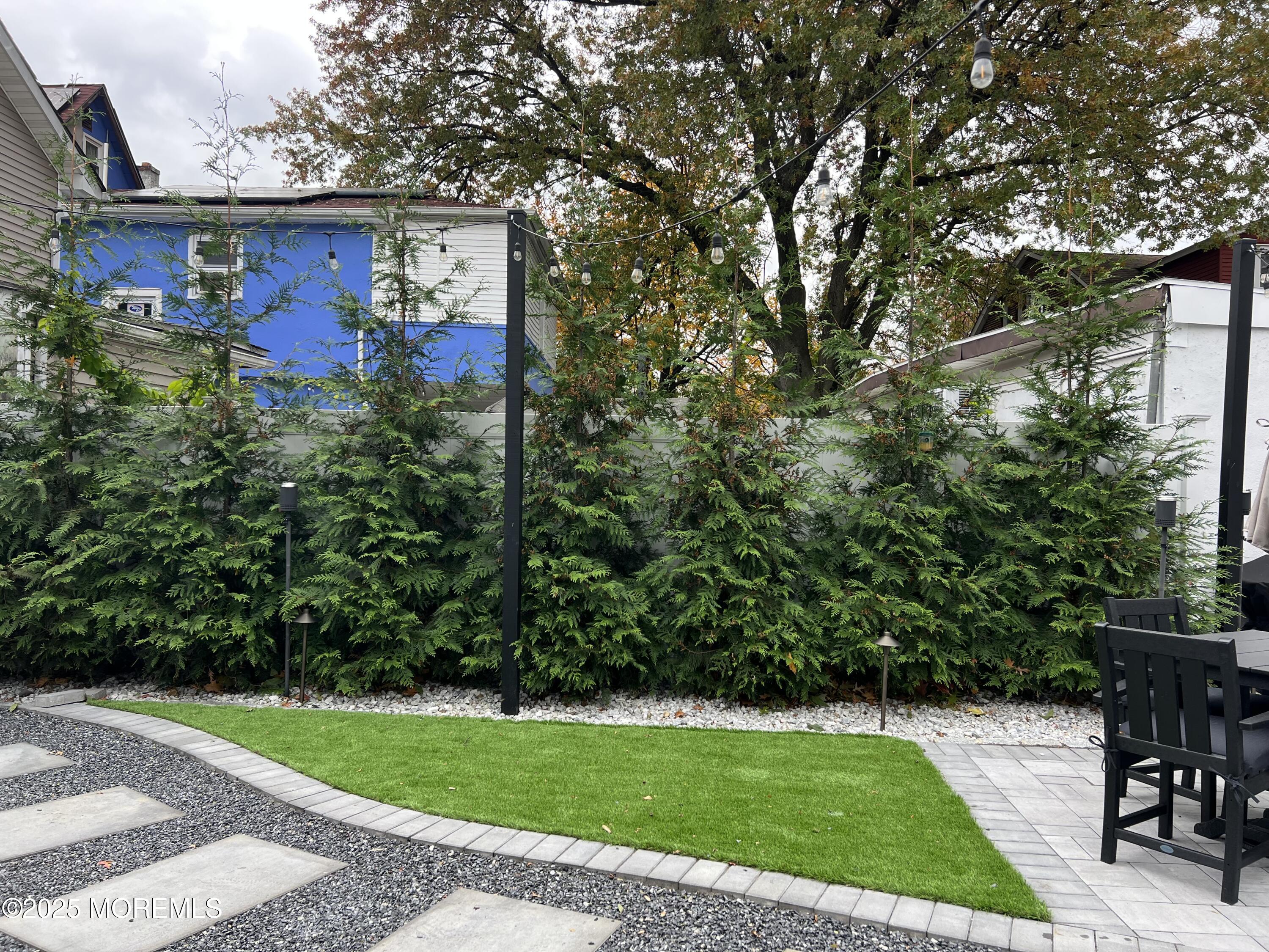 164 Glenwood Avenue, Unit 201 Bloomfield, NJ 07003 - Photo 25 of 26 a view of a chairs and table in the backyard