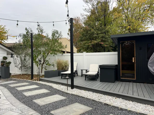 a view of balcony with wooden floor and outdoor seating