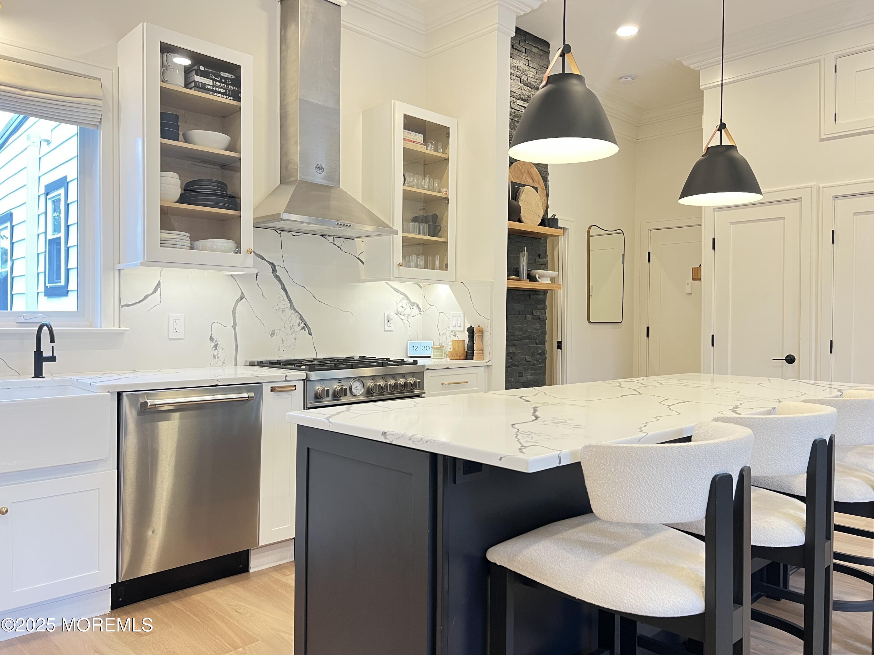 164 Glenwood Avenue, Unit 201 Bloomfield, NJ 07003 - Photo 5 of 26 a kitchen with a dining table chairs and white cabinets