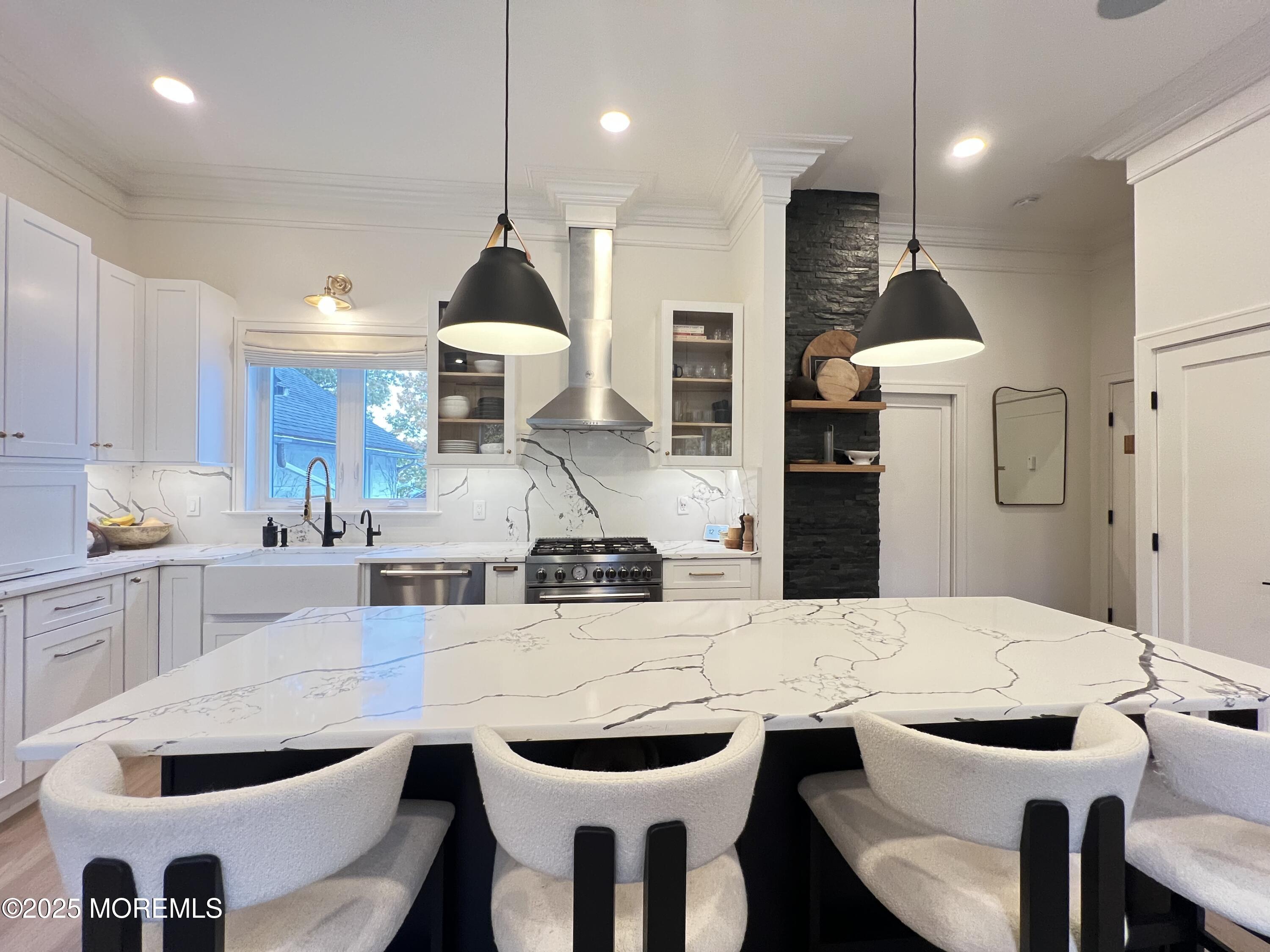 164 Glenwood Avenue, Unit 201 Bloomfield, NJ 07003 - Photo 6 of 26 a kitchen with a dining table chairs stainless steel appliances and cabinets