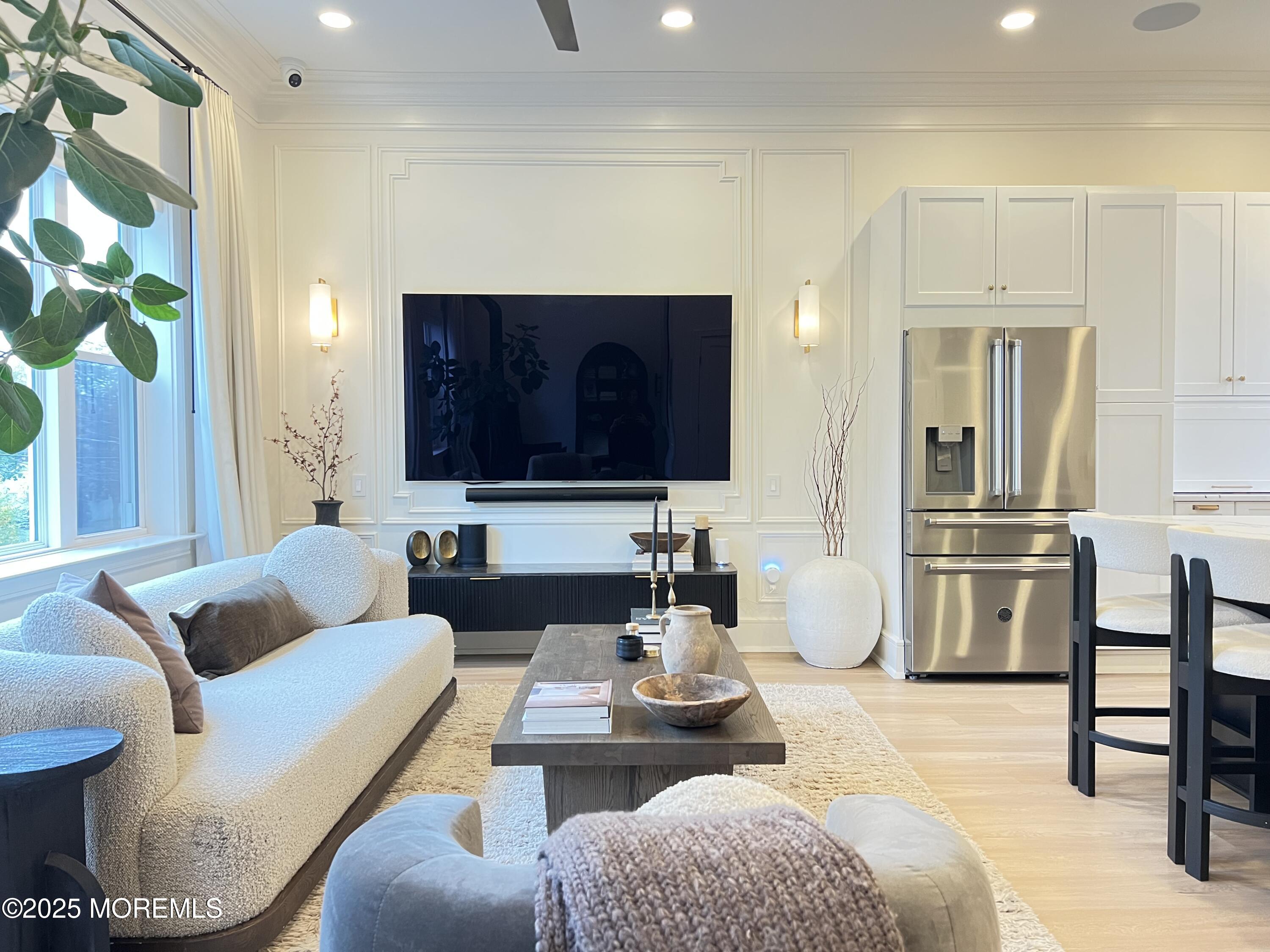 164 Glenwood Avenue, Unit 201 Bloomfield, NJ 07003 - Photo 7 of 26 a living room with furniture and a flat screen tv