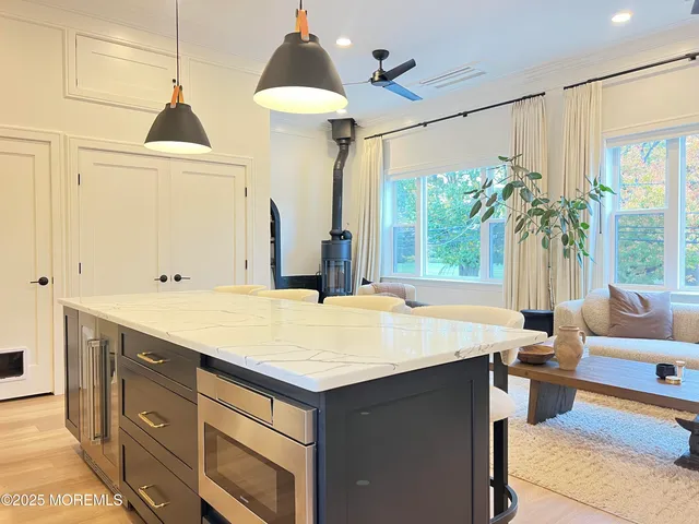 a room with a chandelier and a sink