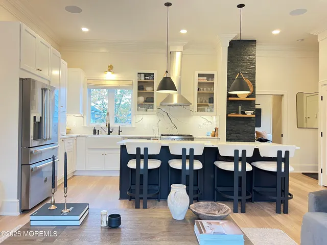 a room with lots of wooden furniture and windows