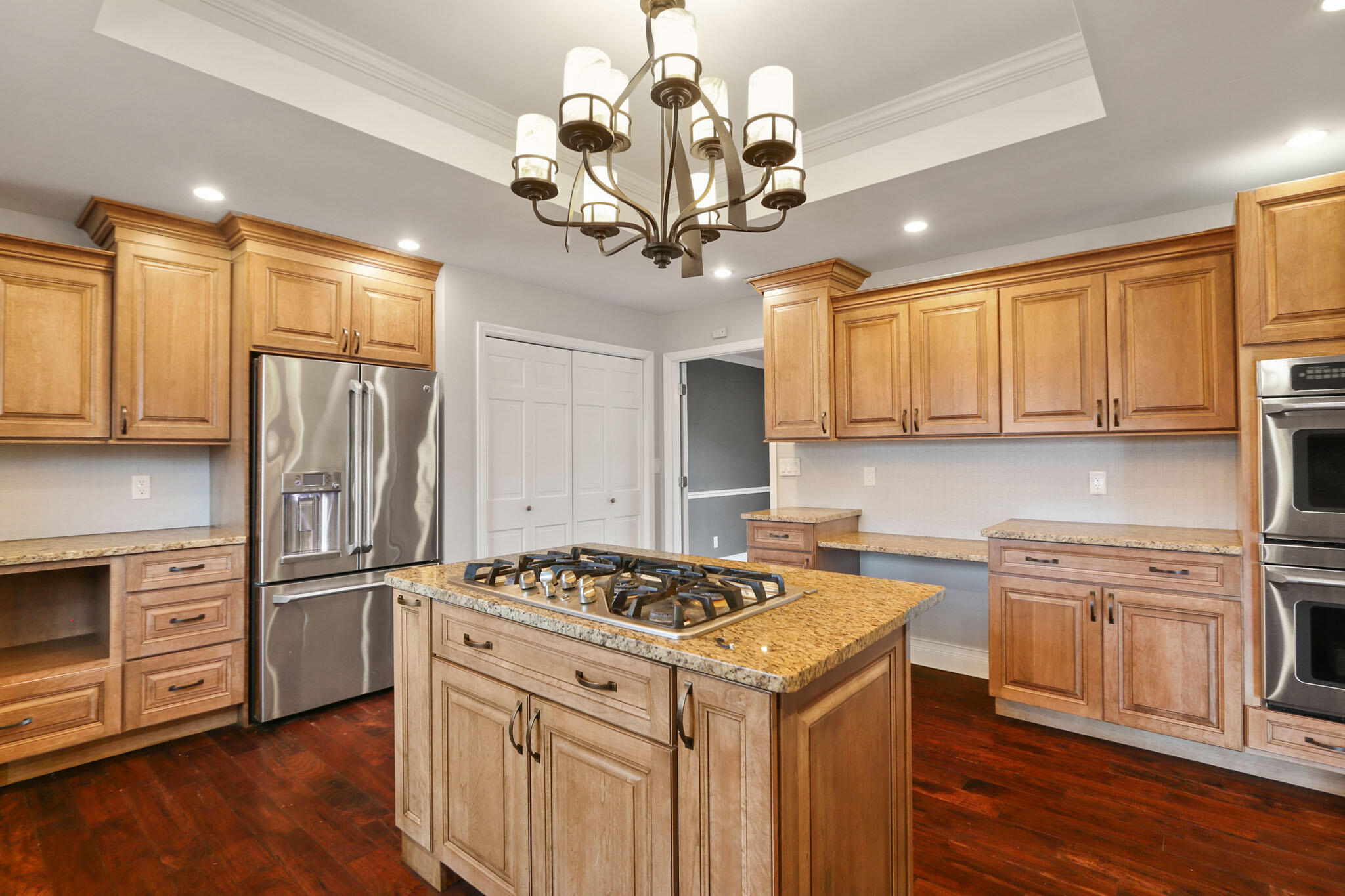 366 Devon Court Valparaiso, IN 46385 - Photo 24 of 45 a kitchen with stainless steel appliances granite countertop a sink a stove a refrigerator cabinets and wooden floor