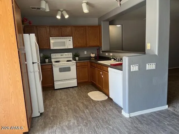 a kitchen with a refrigerator sink and cabinets