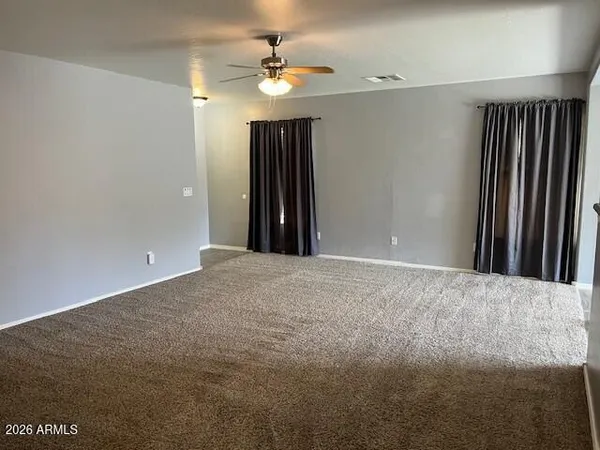 a view of a livingroom with a chandelier fan