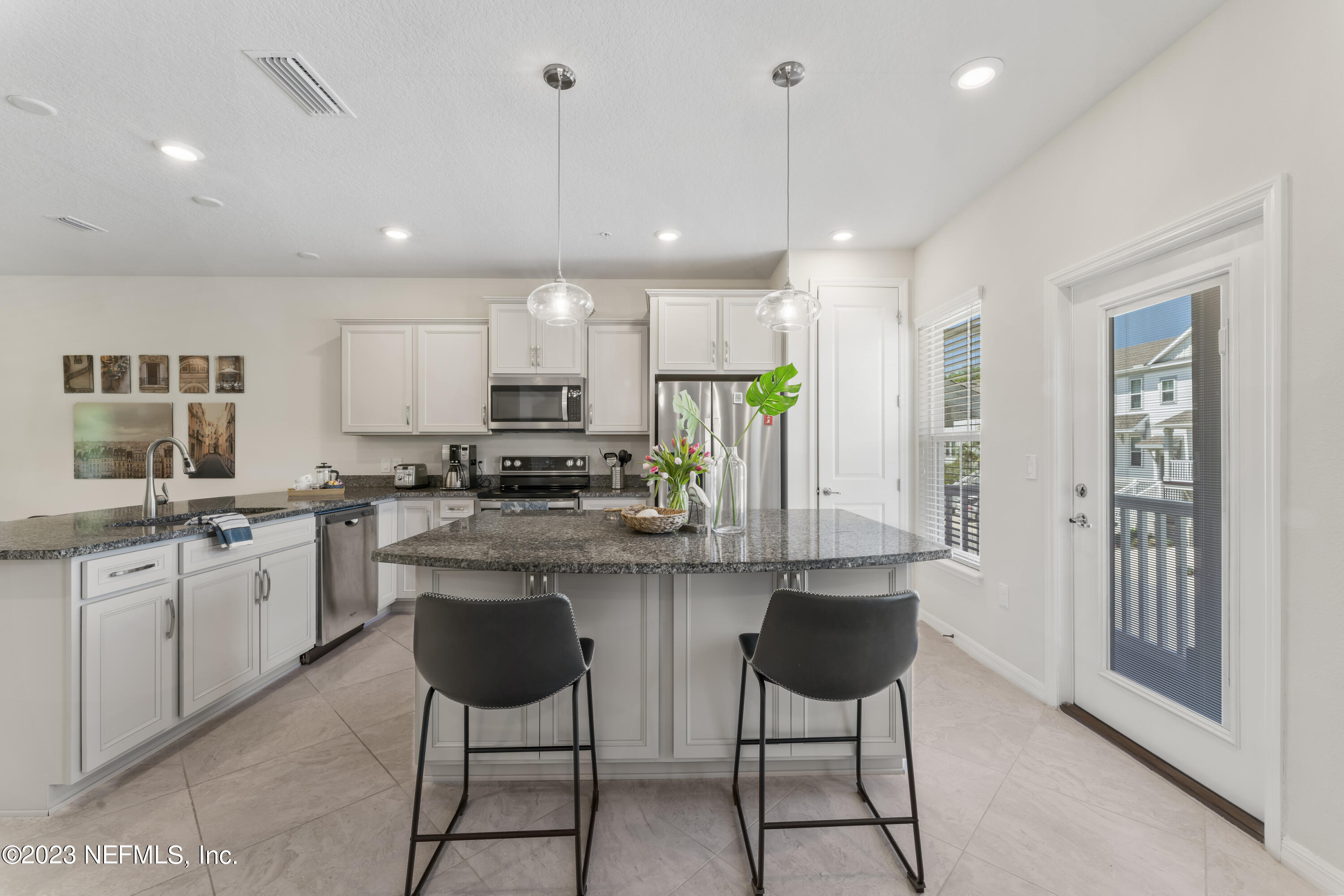 55 Spring Tide Way Ponte Vedra, FL 32081 - Photo 11 of 75 a kitchen with stainless steel appliances granite countertop a stove a sink a oven a dining table and chairs