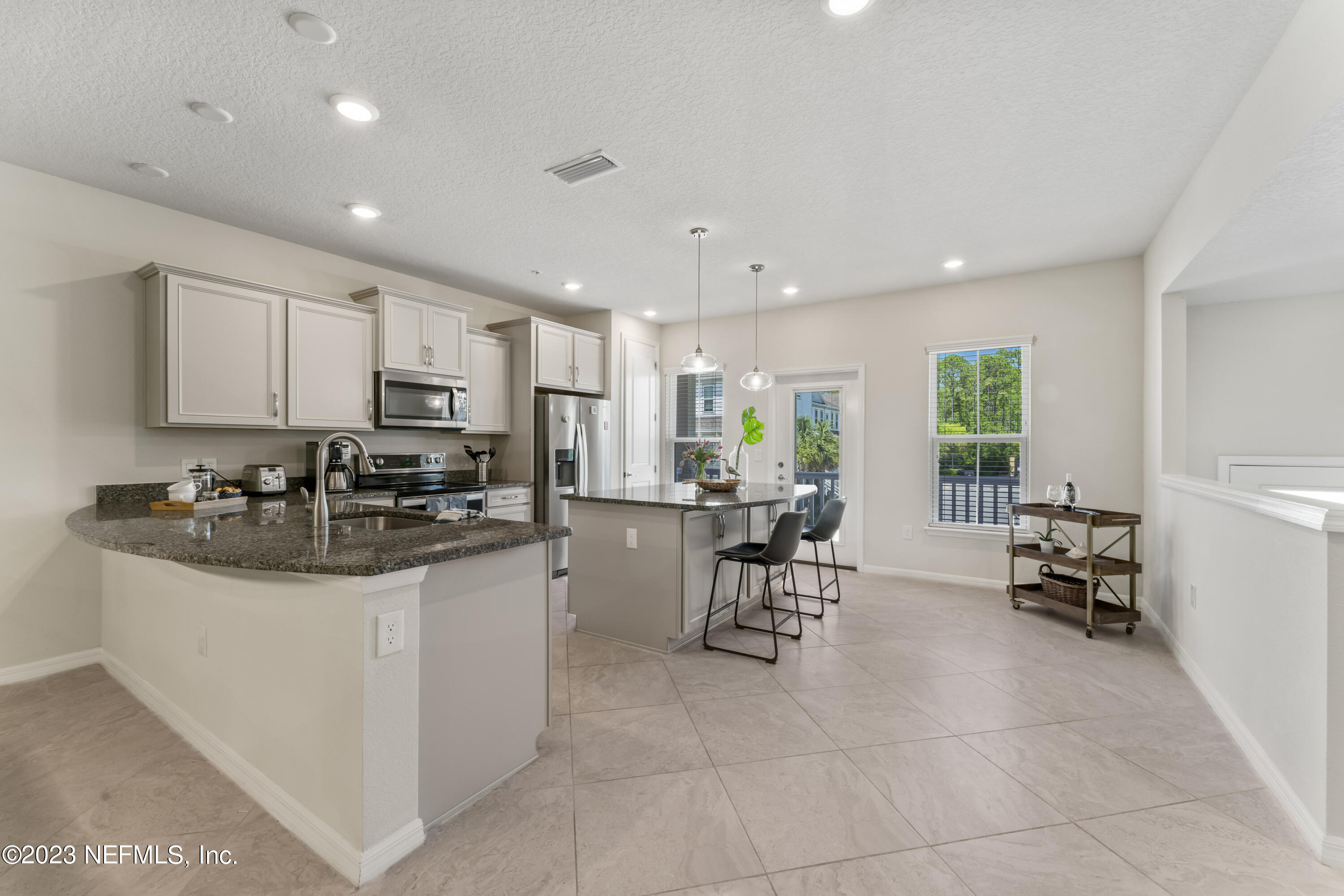 55 Spring Tide Way Ponte Vedra, FL 32081 - Photo 14 of 75 a kitchen with stainless steel appliances granite countertop a sink and a refrigerator