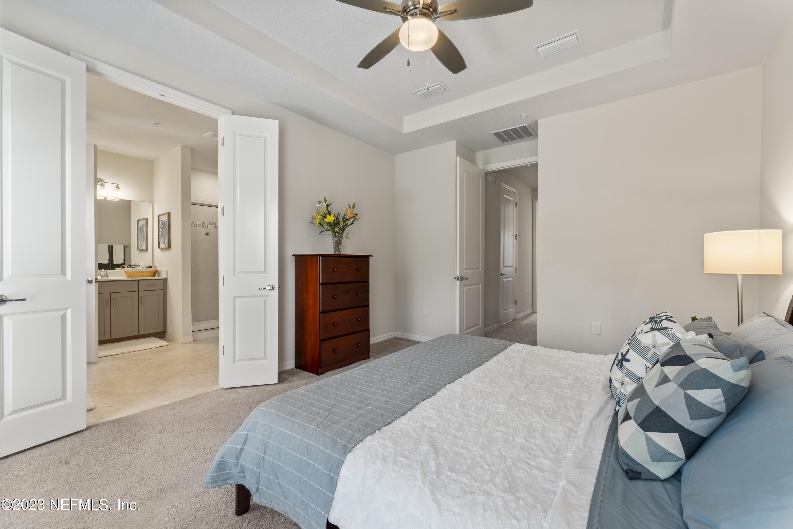 55 Spring Tide Way Ponte Vedra, FL 32081 - Photo 30 of 75 a bedroom with a bed and a chandelier