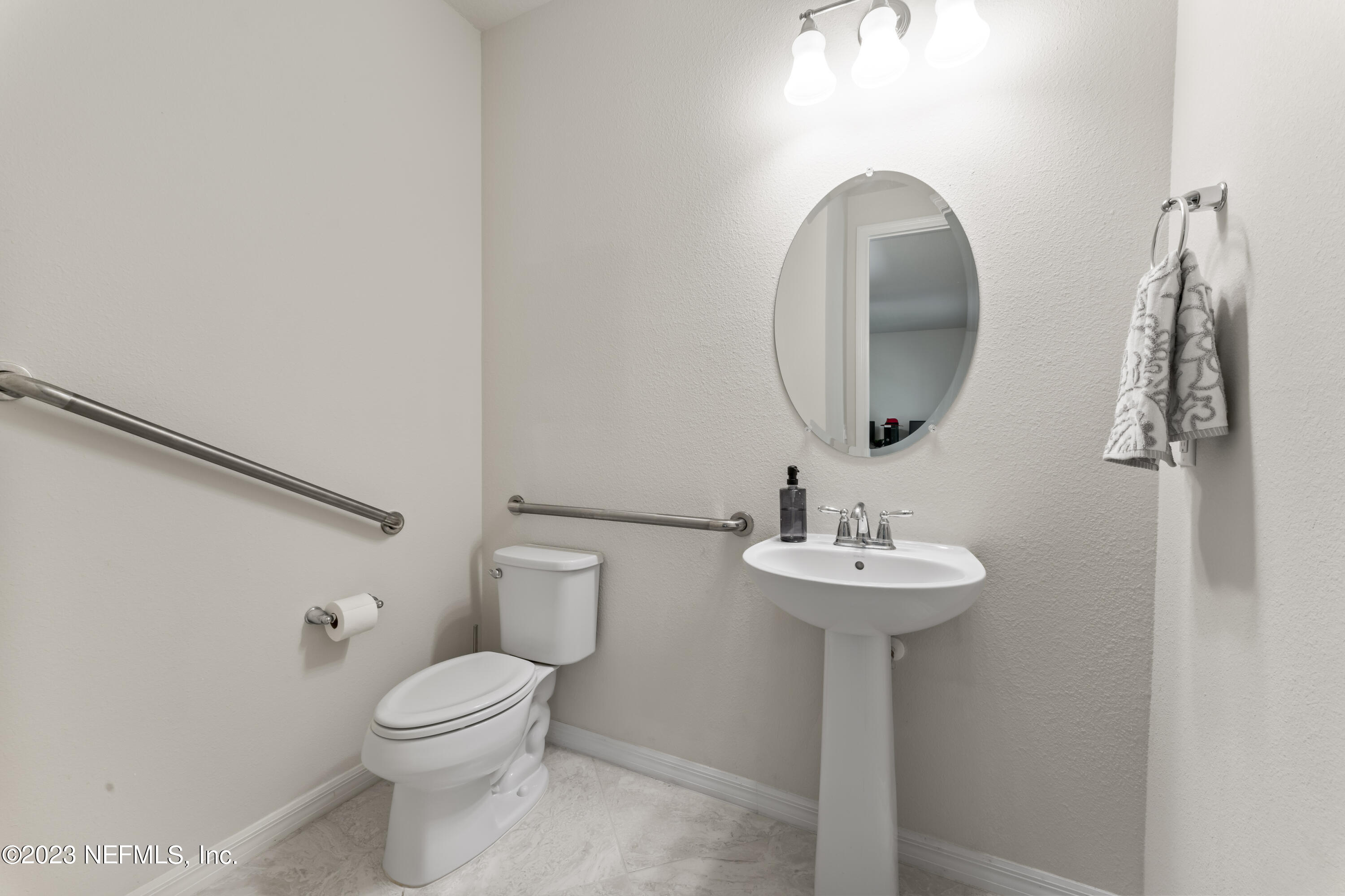 55 Spring Tide Way Ponte Vedra, FL 32081 - Photo 45 of 75 a bathroom with a sink a toilet and a mirror