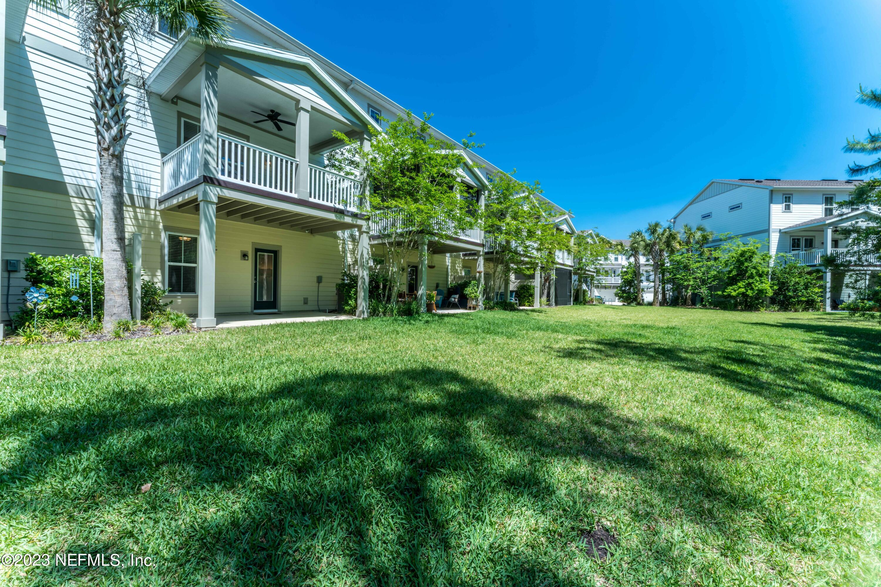 55 Spring Tide Way Ponte Vedra, FL 32081 - Photo 50 of 75 a view of a white house with a big yard and potted plants and large trees