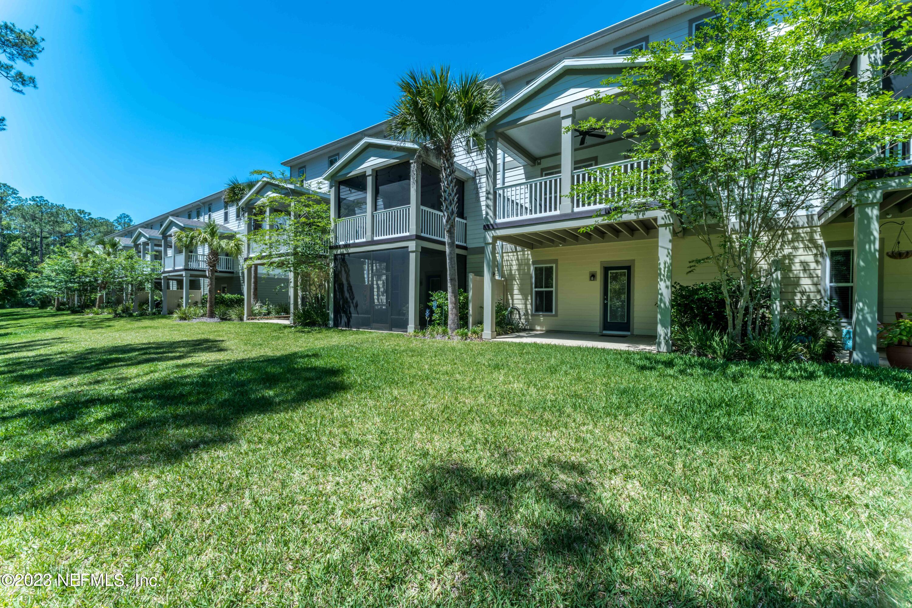 55 Spring Tide Way Ponte Vedra, FL 32081 - Photo 51 of 75 a view of a white house with a big yard and potted plants and large trees