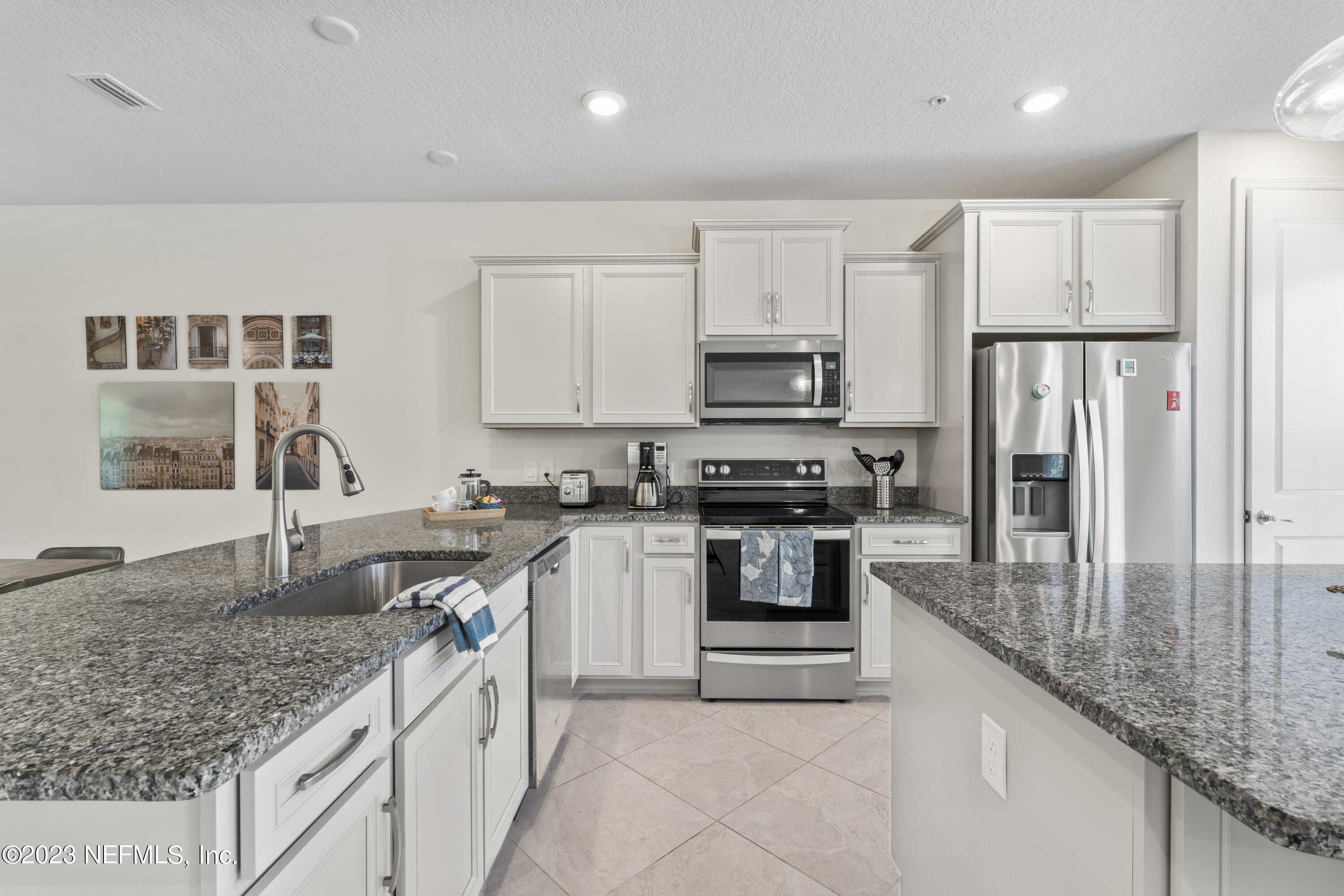55 Spring Tide Way Ponte Vedra, FL 32081 - Photo 7 of 75 a kitchen with stainless steel appliances granite countertop a sink stove and refrigerator