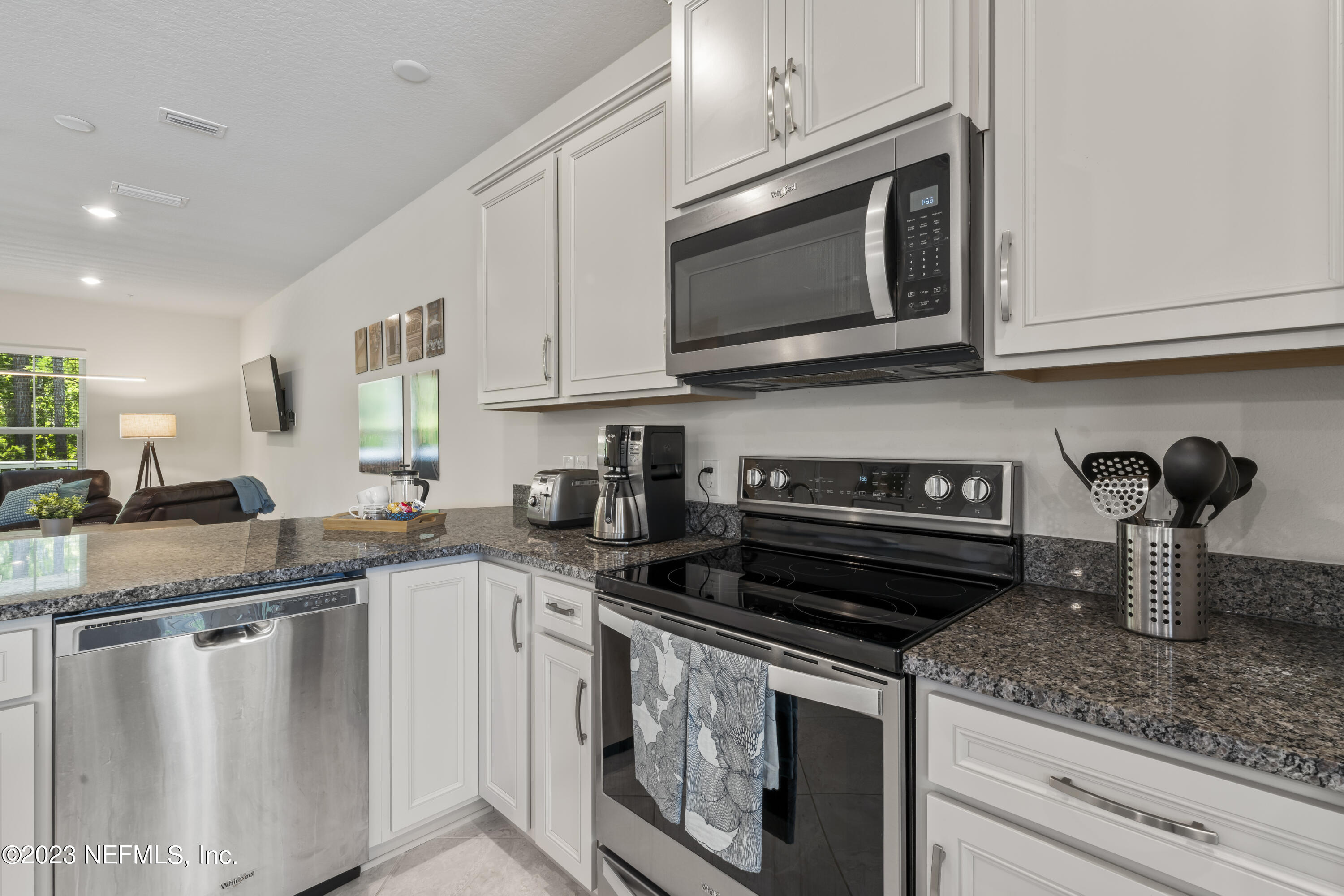 55 Spring Tide Way Ponte Vedra, FL 32081 - Photo 8 of 75 a kitchen with stainless steel appliances granite countertop a sink stove and microwave