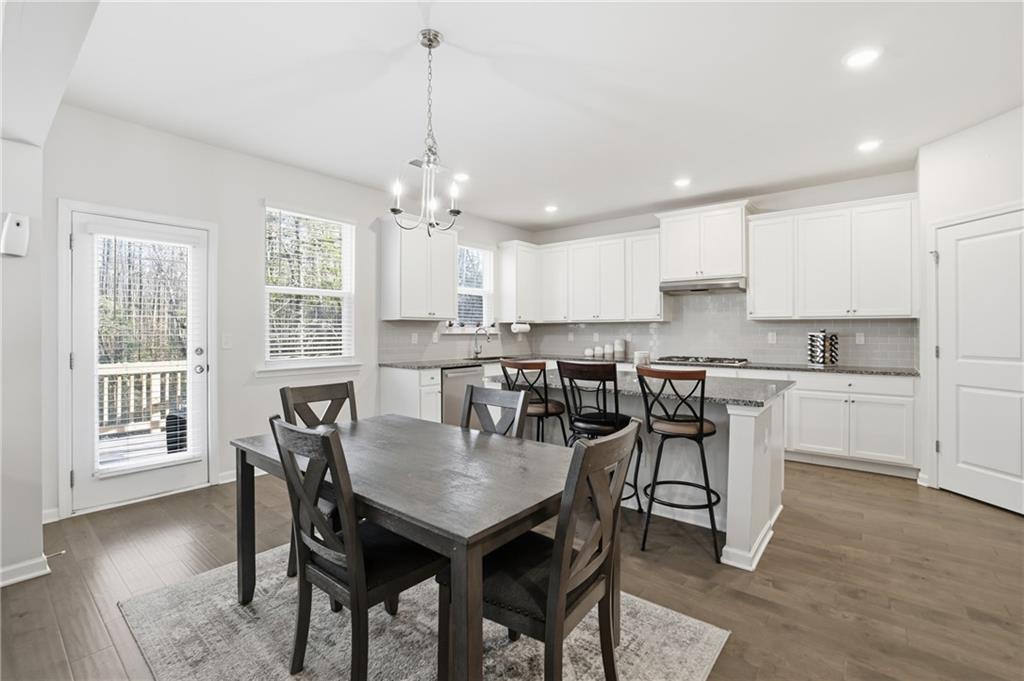 175 Paxton Lane Jefferson, GA 30549 - Photo 7 of 39 a view of a dining room and livingroom with furniture wooden floor a chandelier