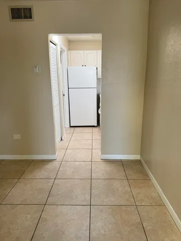 a view of a refrigerator in kitchen