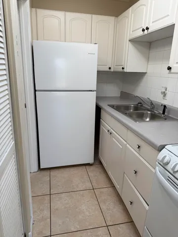 a white refrigerator freezer sitting in a kitchen