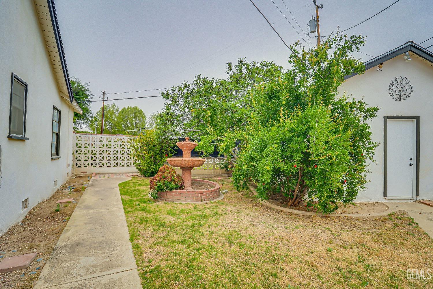 Undisclosed Address Bakersfield, CA 93305 - Photo 22 of 24 a front view of a house with a yard