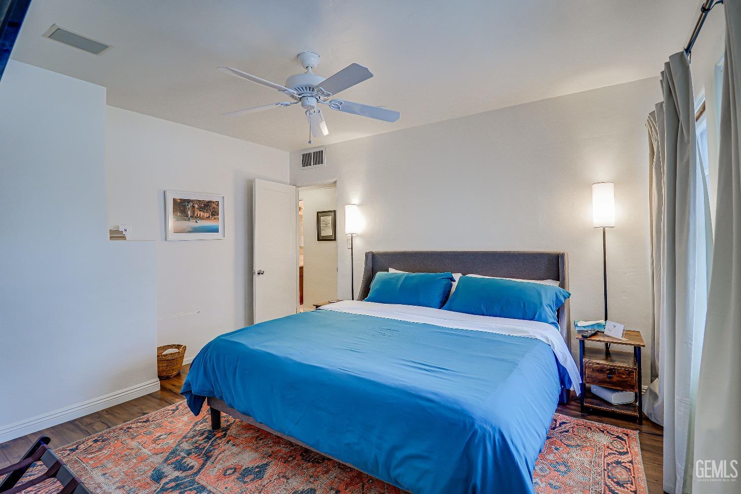 Undisclosed Address Bakersfield, CA 93305 - Photo 9 of 24 a bedroom with a bed and wooden floor