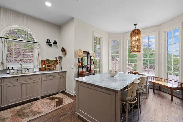 a open kitchen with sink cabinets and dining table