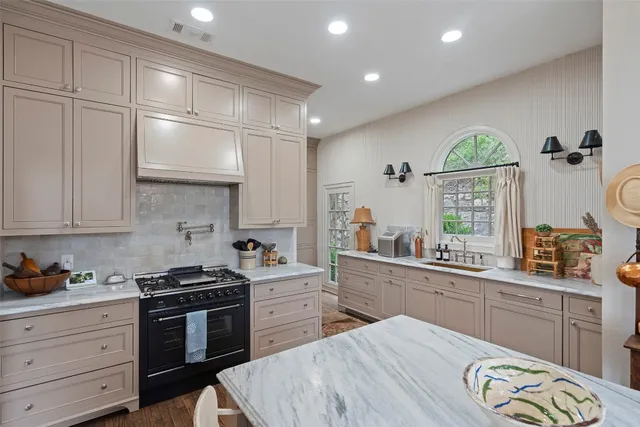 a kitchen with a sink stove and cabinets