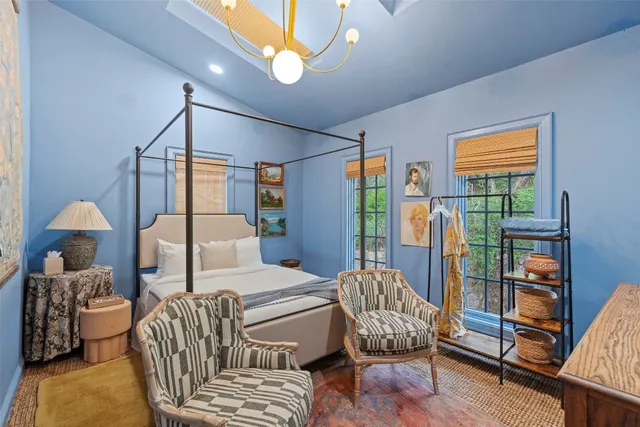 a bedroom with furniture and a window