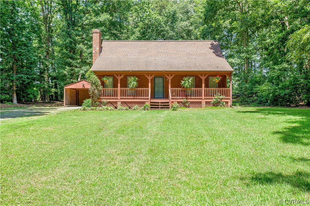 a front view of a house with a yard and trees