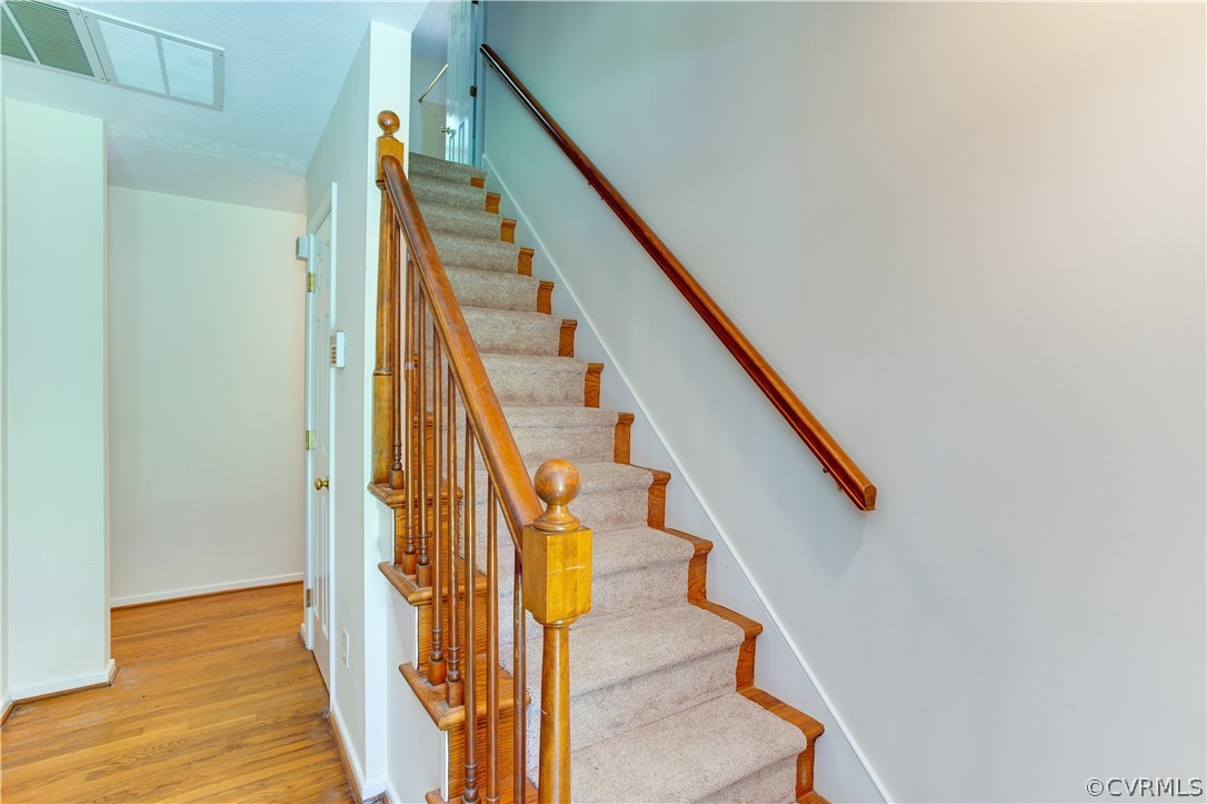 7460 Strath Road Henrico, VA 23231 - Photo 19 of 32 a view of staircase with wooden floor and white walls