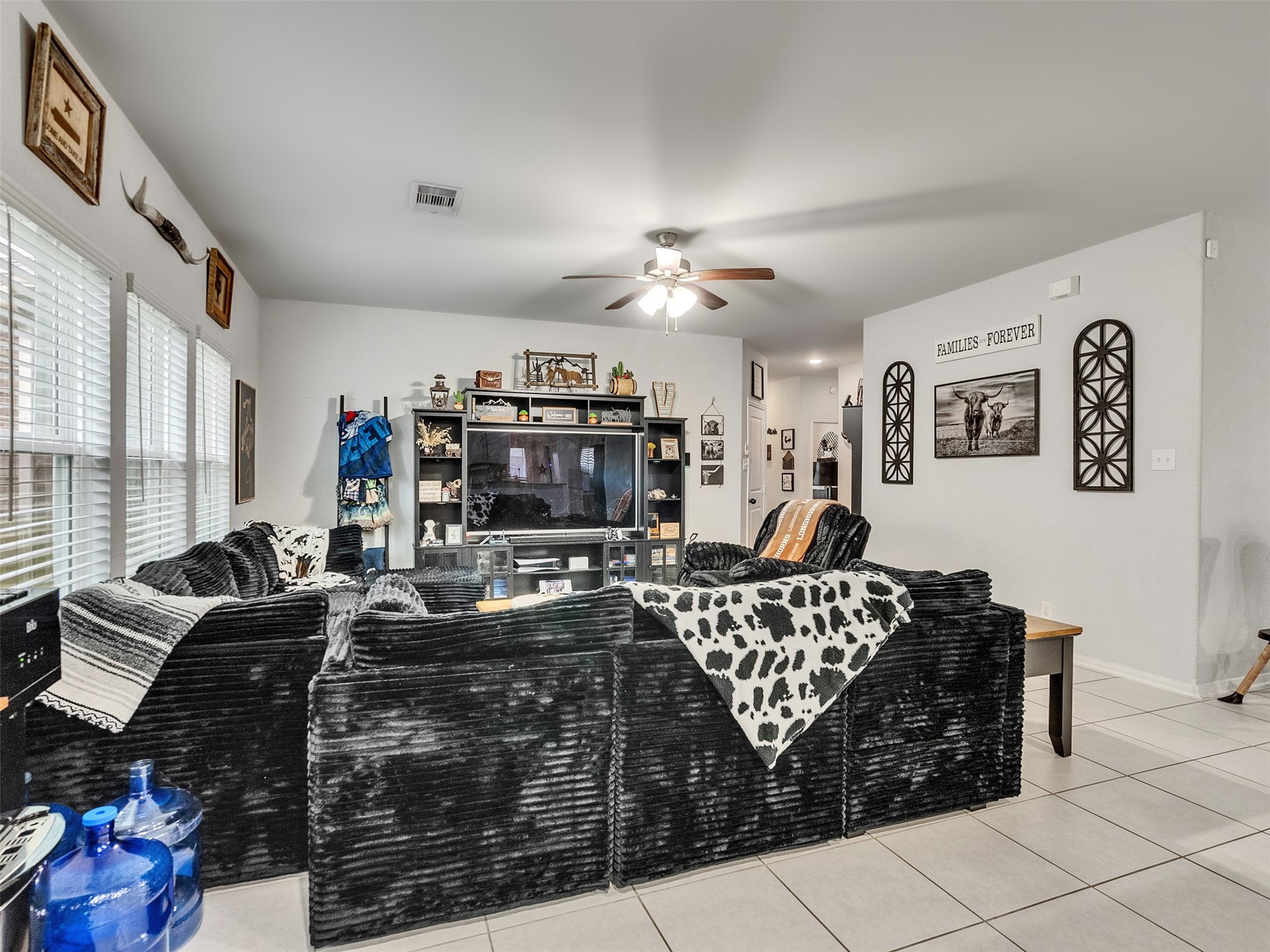 8719 Willet Street Baytown, TX 77521 - Photo 16 of 42 a living room with furniture a couch and a flat screen tv
