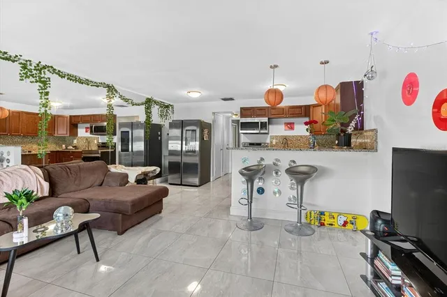 a kitchen with stainless steel appliances granite countertop a sink and a microwave