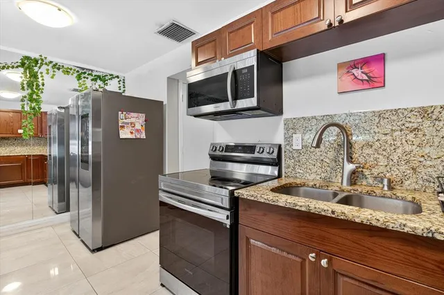 a living room with furniture and flower pot