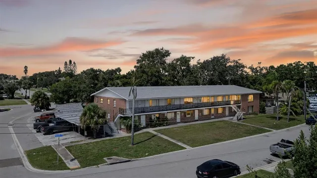 a aerial view of a house next to a yard
