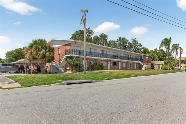 a bedroom with furniture and a fan