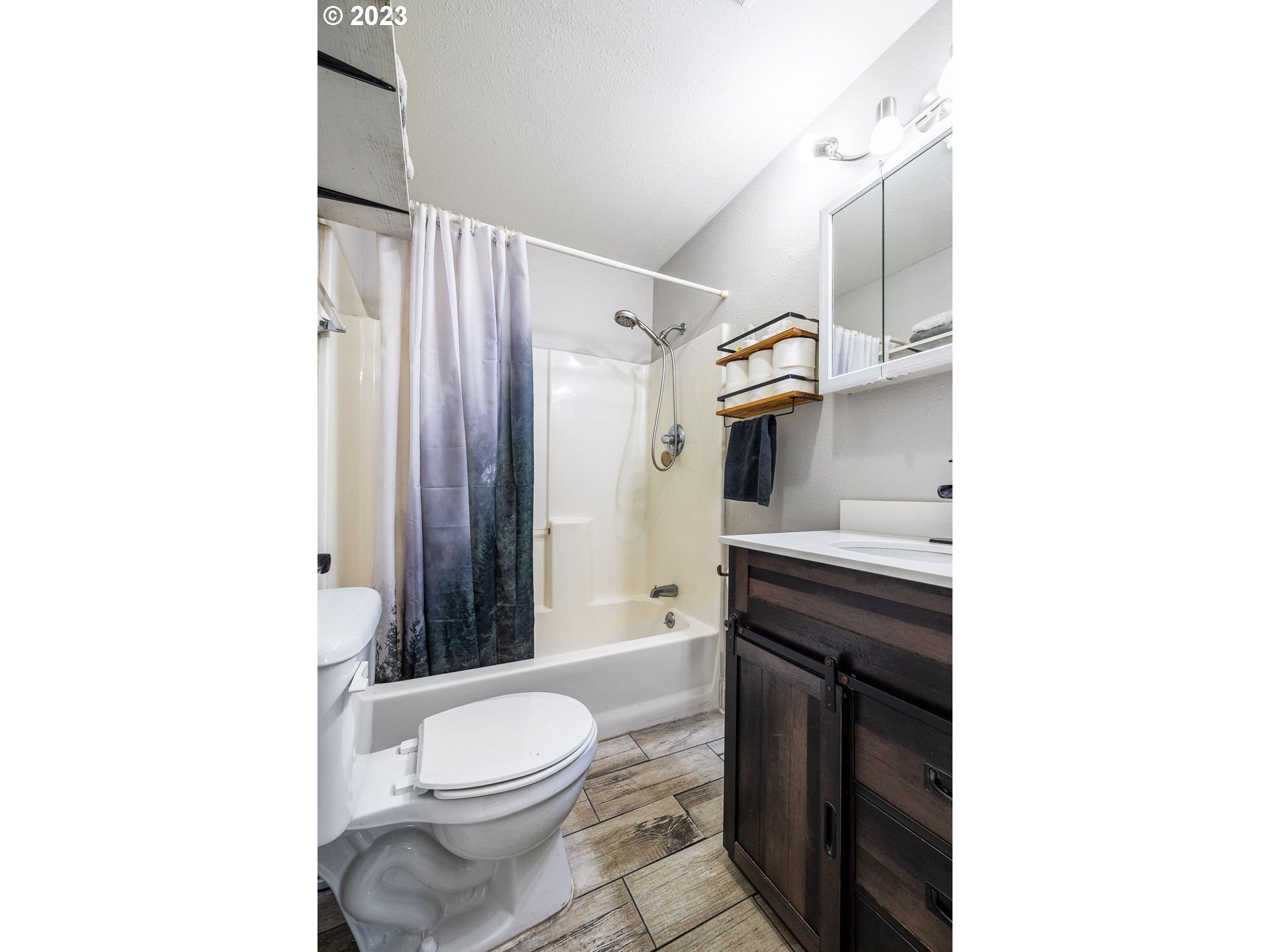 2065 G Street Springfield, OR 97477 - Photo 15 of 37 a bathroom with a sink a toilet and shower