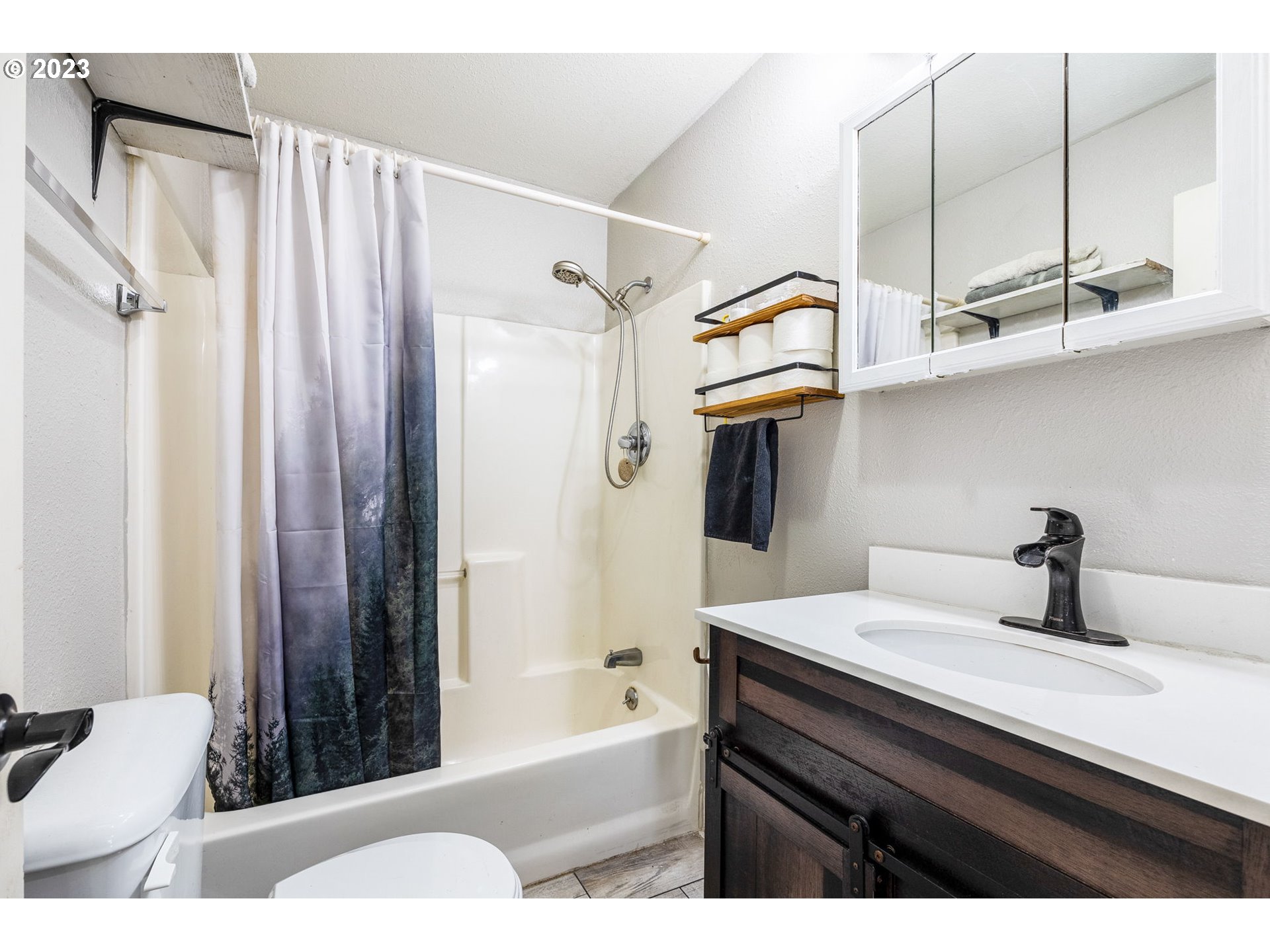 2065 G Street Springfield, OR 97477 - Photo 16 of 37 a bathroom with a sink a toilet and shower