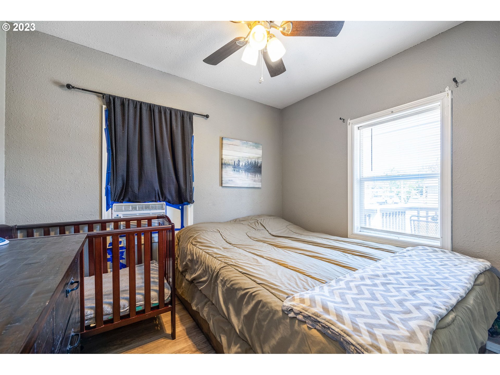 2065 G Street Springfield, OR 97477 - Photo 18 of 37 a bedroom with a bed and a chandelier