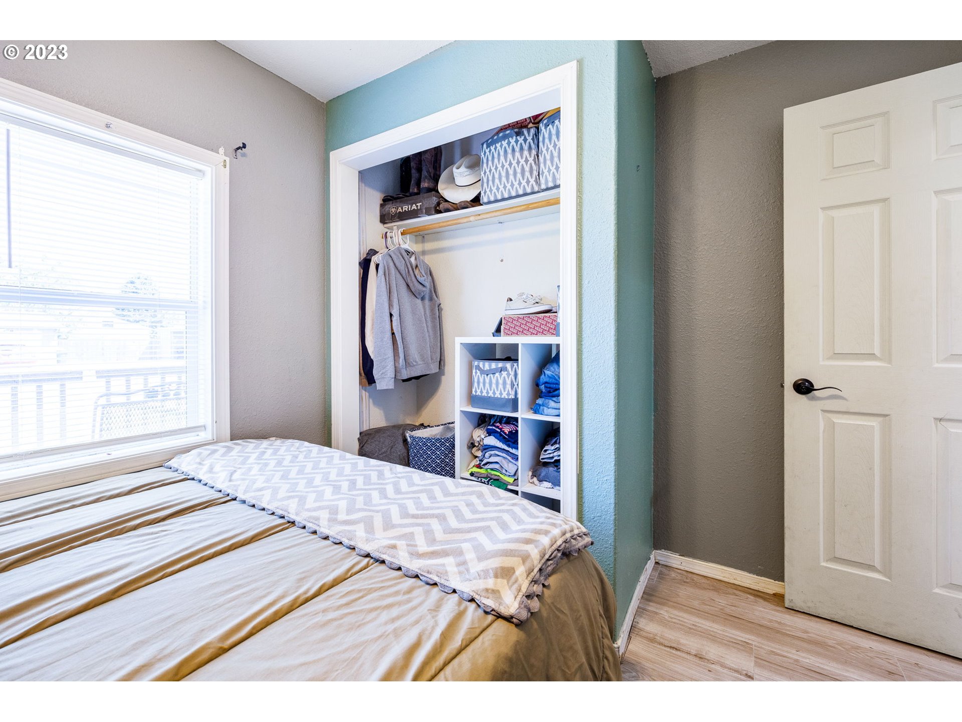 2065 G Street Springfield, OR 97477 - Photo 19 of 37 a bedroom with a bed and a bookshelf