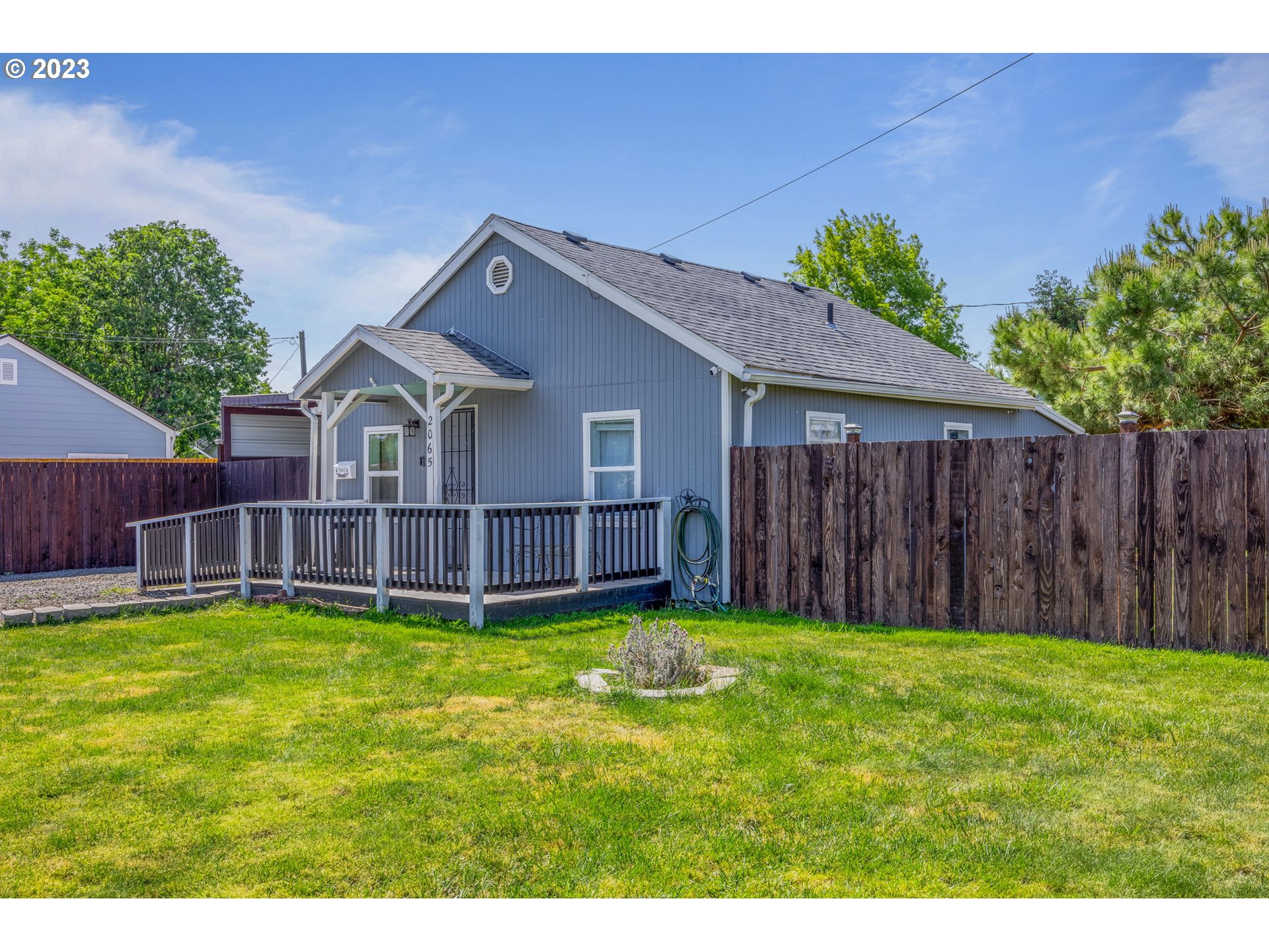 2065 G Street Springfield, OR 97477 - Photo 2 of 37 a view of a house with a yard and a wooden fence