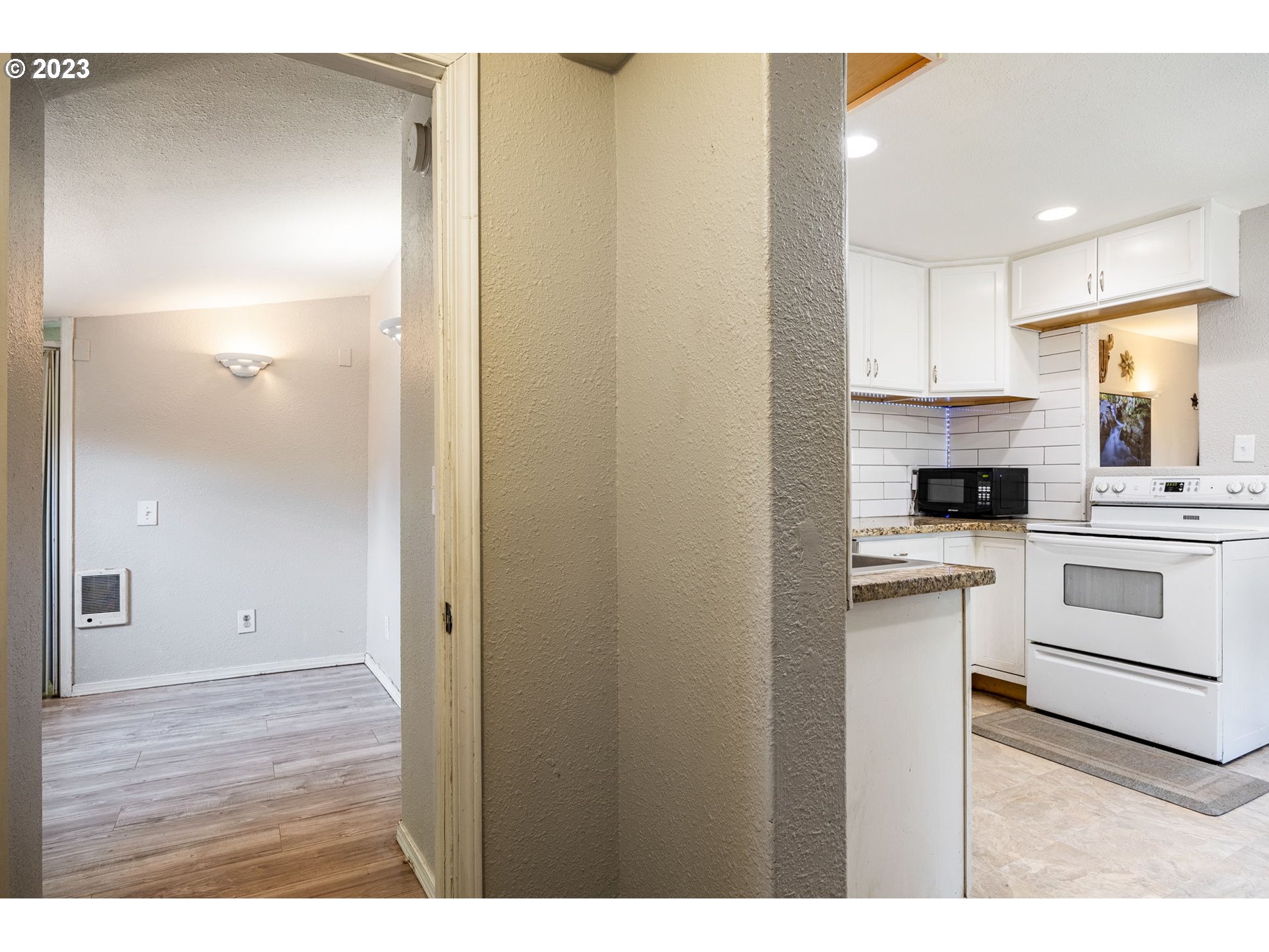 2065 G Street Springfield, OR 97477 - Photo 22 of 37 a kitchen with a refrigerator and white cabinets