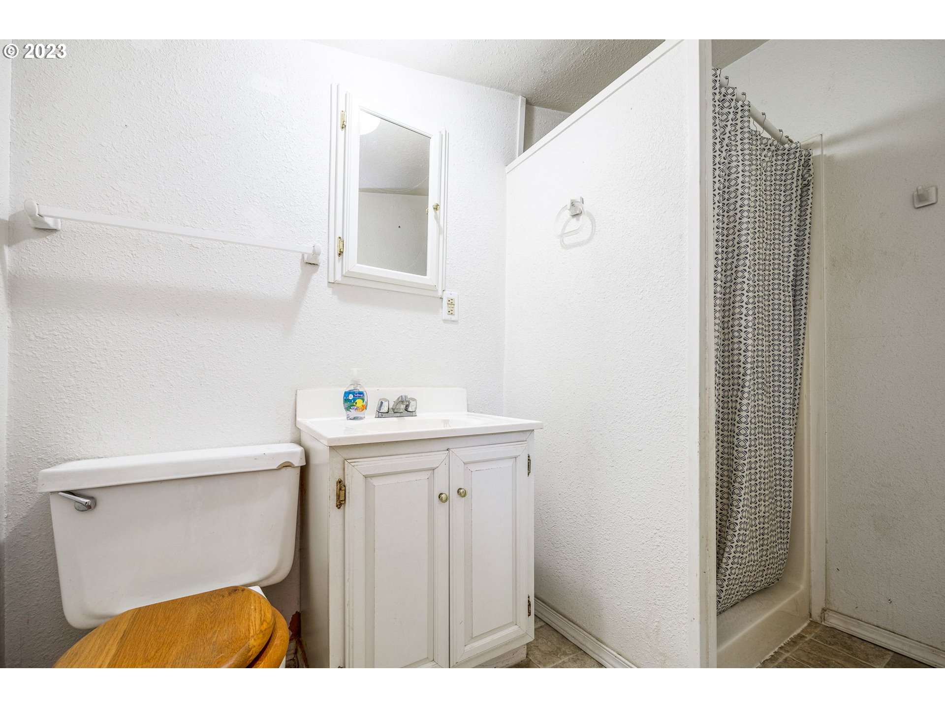 2065 G Street Springfield, OR 97477 - Photo 24 of 37 a bathroom with a sink a toilet and mirror