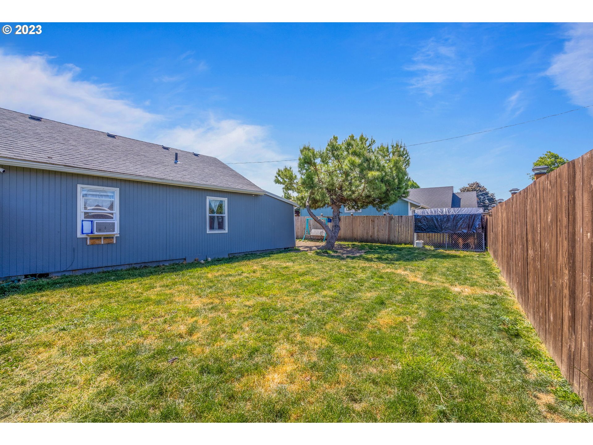 2065 G Street Springfield, OR 97477 - Photo 25 of 37 a backyard of a house with lots of green space