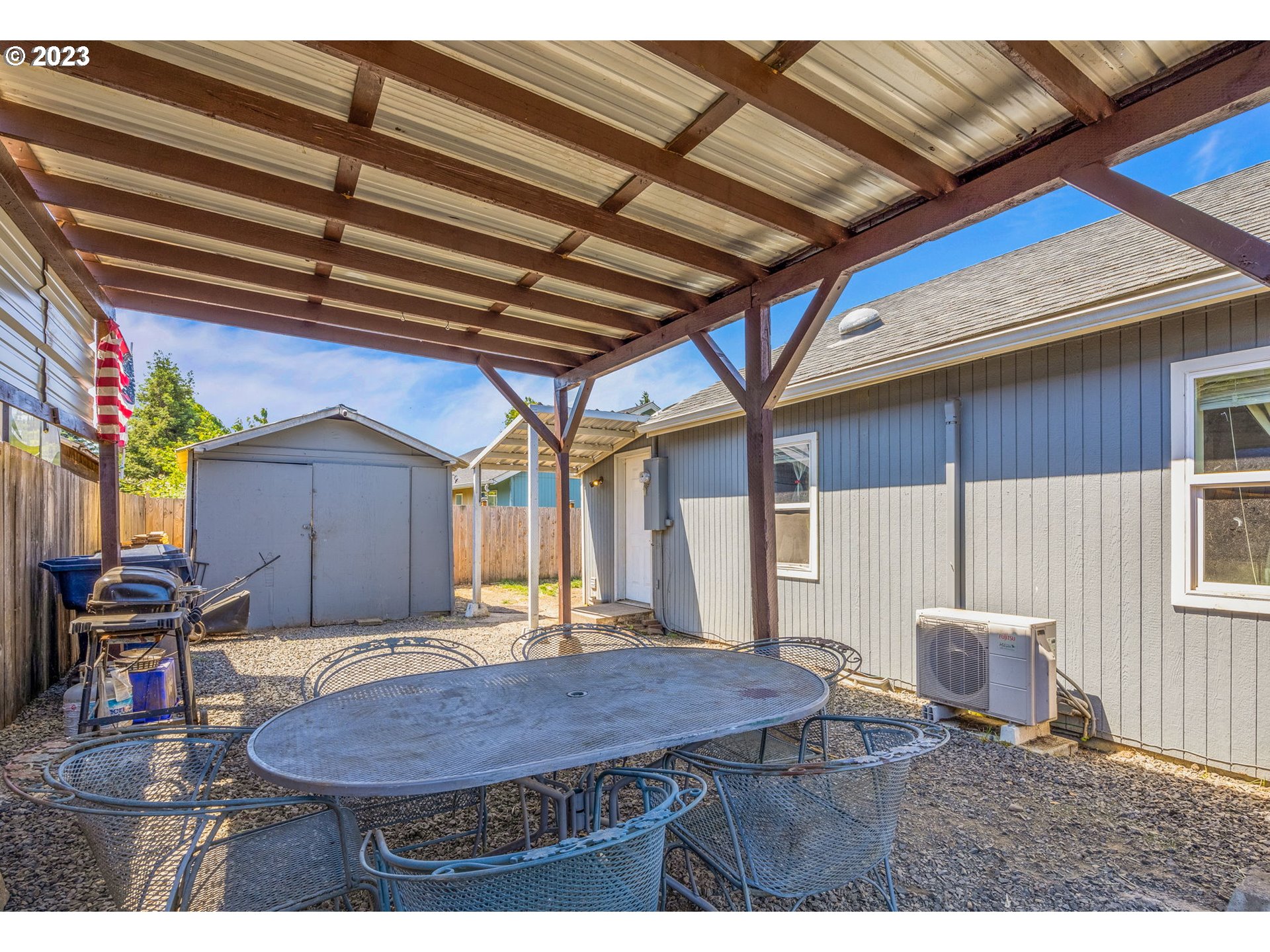 2065 G Street Springfield, OR 97477 - Photo 32 of 37 a backyard of a house with barbeque oven table and chairs